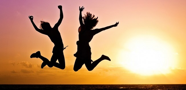 Two Young People Jumping for Joy (Beach at Sunset)