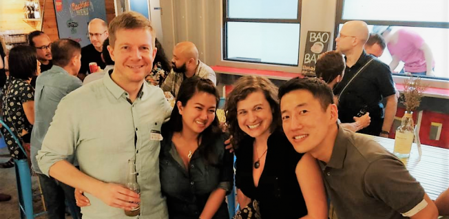 Two Men &amp; Two Women Smiling into Camera